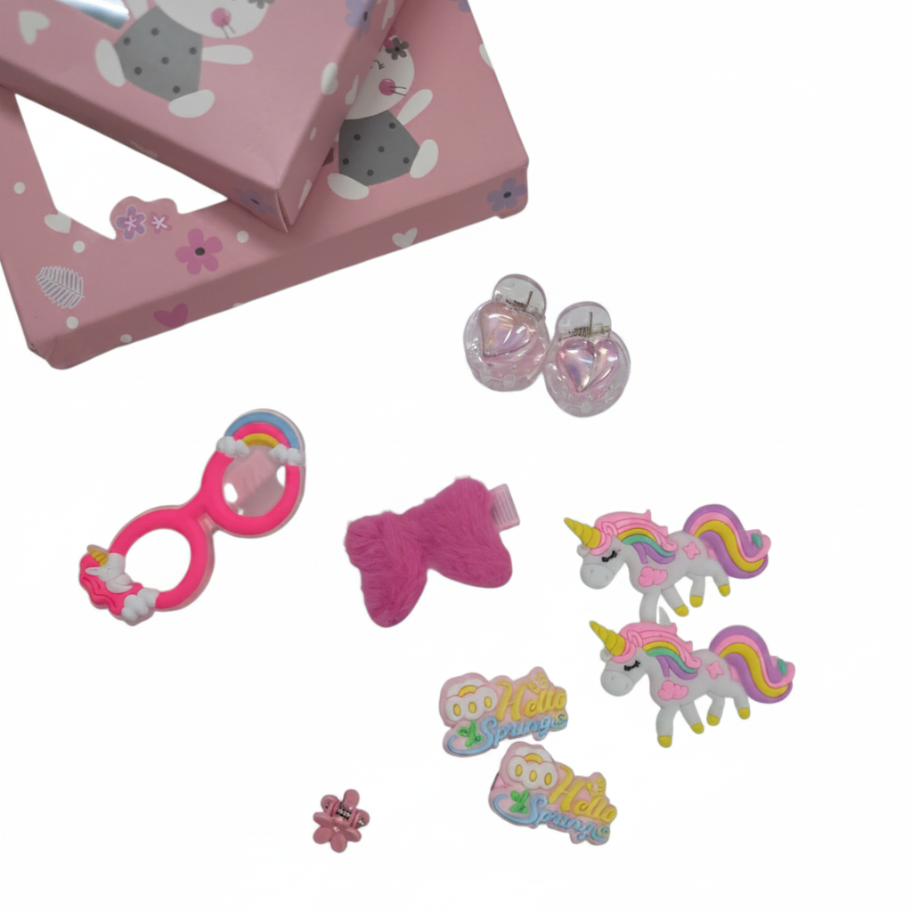 Pink children's hair accessories set with unicorn-themed accessories on a white background